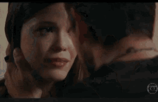a man and a woman are kissing each other in a movie .