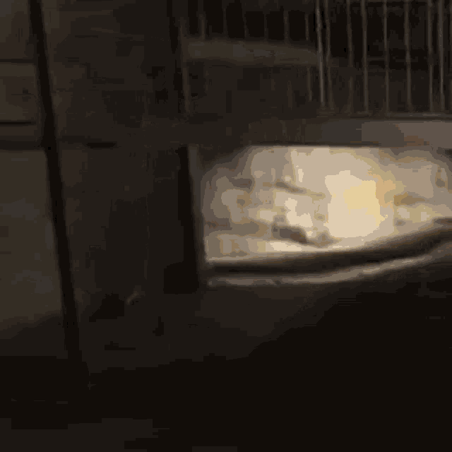 a person is standing in a dark room with a light coming out of the ceiling .