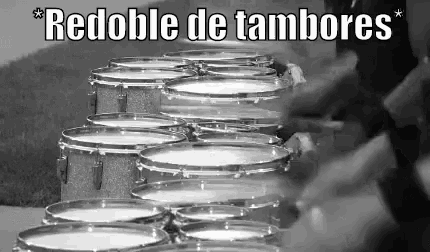a black and white photo of a marching band playing drums in a row .
