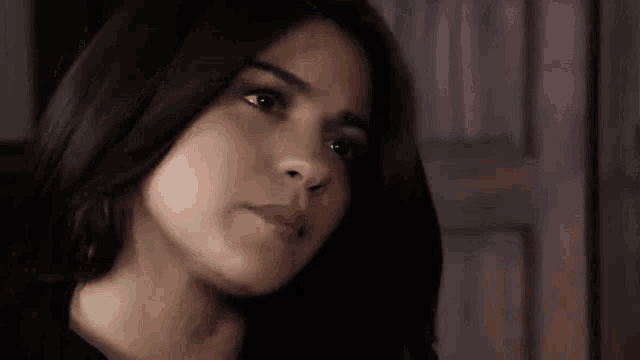 a close up of a woman 's face with her eyes closed and her mouth open .