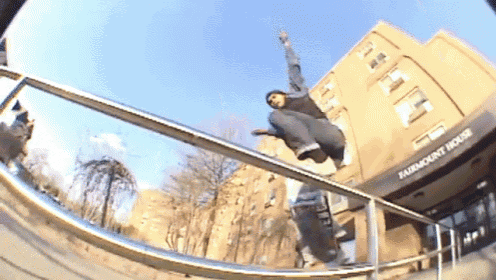 a skateboarder is doing a trick on a railing in front of a building that says fairmount house