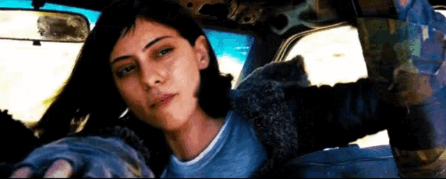 a woman is sitting in the back seat of a car