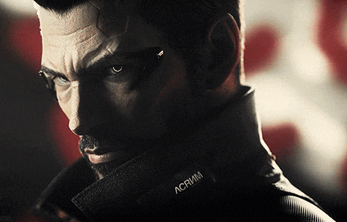 a close up of a man 's face with a label on his collar that says acrim