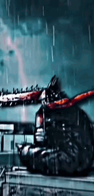 a person is holding a chainsaw in a dark room in the rain .