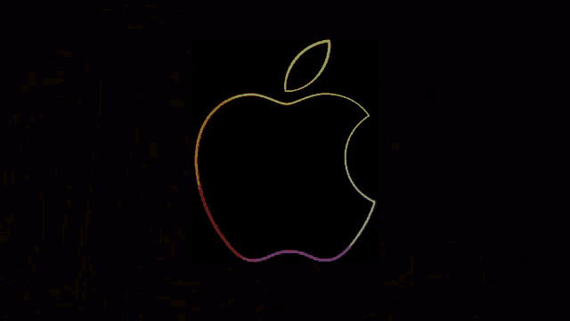 a colorful apple on a black background with a leaf