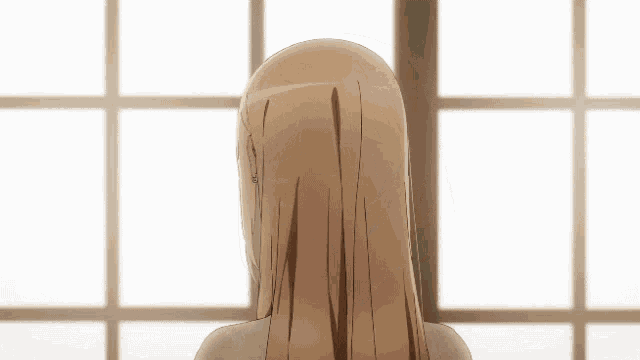 a woman with long blonde hair is touching her hair with her hand