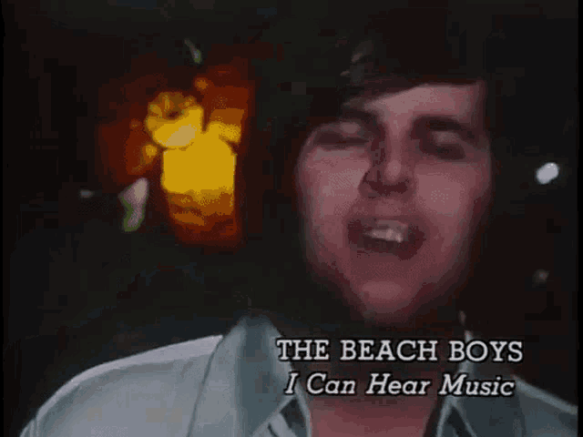 a man is singing the beach boys i can hear music in a video .