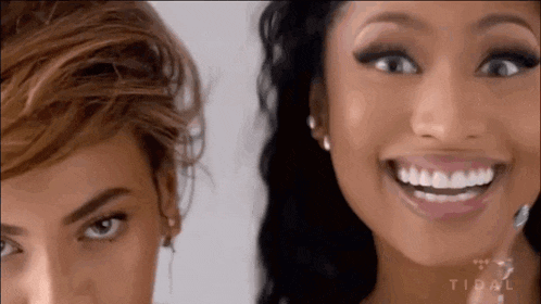 a close up of two women 's faces with the word tidal on the bottom right