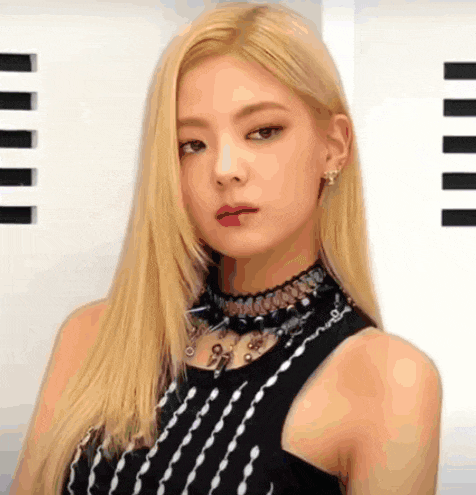 a close up of a woman with blonde hair wearing a choker and a black top .