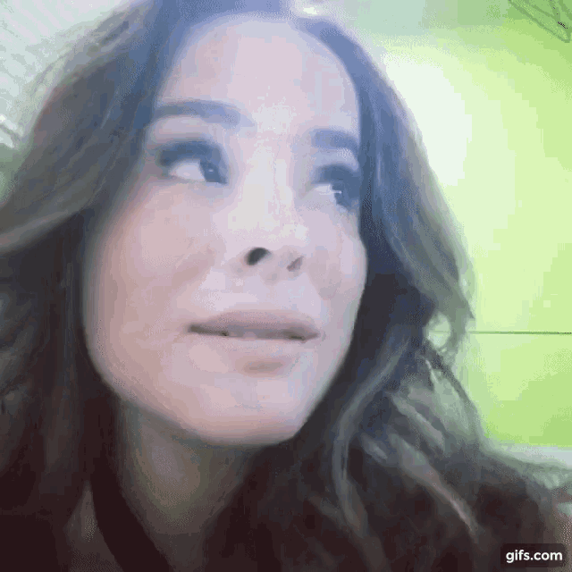 a close up of a woman 's face with the website gifs.com at the bottom of the image