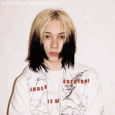 a girl with long blonde hair is wearing a shirt that says ' amme ' on it