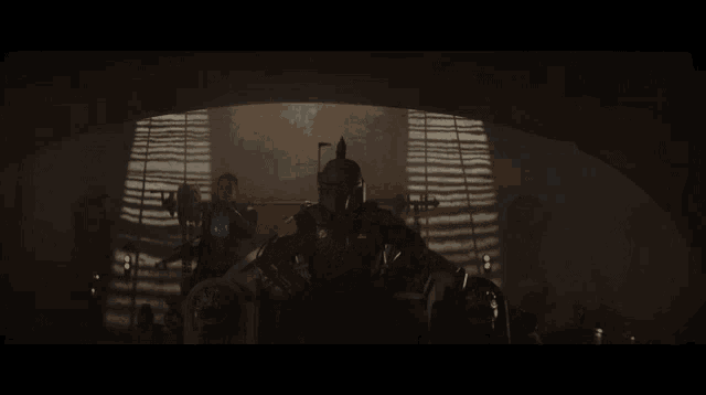 boba fett is sitting in a dark room with a window