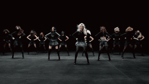 a group of female dancers are laying on the ground