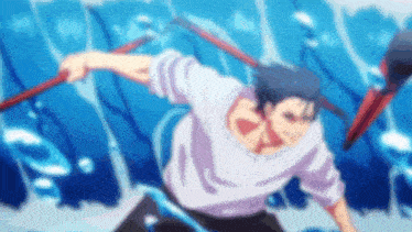 a man in a white shirt is holding two sticks in his hands in front of a blue wall .