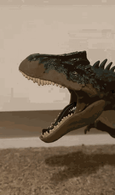 a close up of a toy dinosaur with its mouth wide open