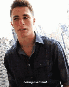 a young man in a blue shirt is talking about eating as a talent
