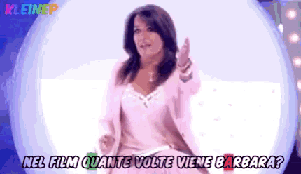 a woman in a pink jacket is standing in front of a white globe with the words nel film quante volte viene barbara