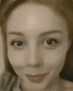 a close up of a woman 's face without makeup .
