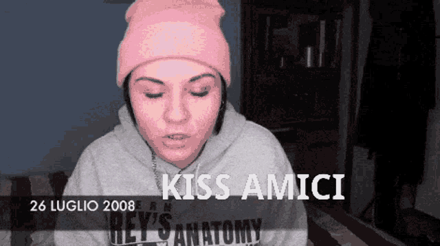 a woman wearing a pink beanie and a grey 's anatomy sweatshirt