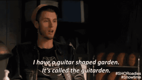 a man wearing a hat and a leather jacket says i have a guitar shaped garden .