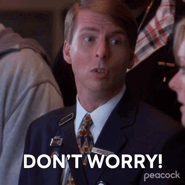 a man in a suit and tie is saying " don 't worry "