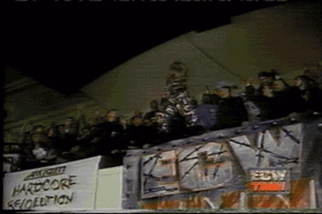 a crowd of people watching a concert with a sign that says hardcore sexploitation