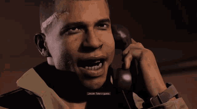a man is talking on a phone and the words lincoln take a guess are on the screen