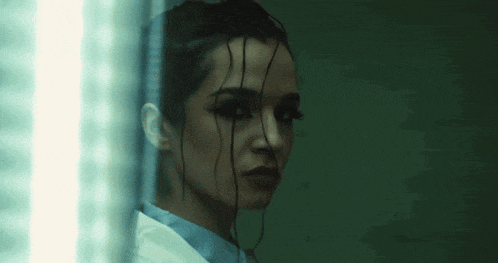 a close up of a woman 's face with a dark background