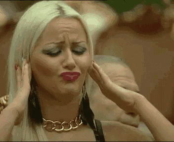 a woman with blonde hair and red lips is covering her ears