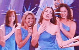 a woman in a blue dress is surrounded by other women