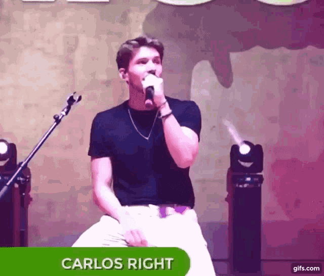 a young man singing into a microphone with the name carlos right on the bottom right