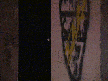 a dark room with graffiti on the wall that says ' a '