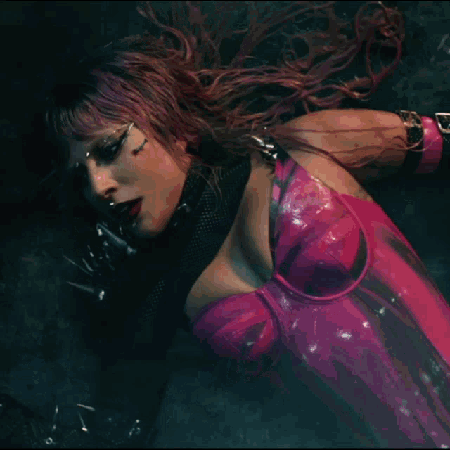 a woman with purple hair and a pink bodysuit