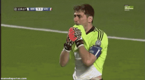 a soccer player with his mouth open during a game with the score atl