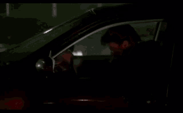 a man is driving a car with the words fuckin embarrassing written on it