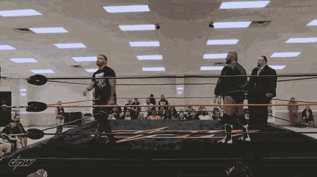 a wrestling ring with a crow logo on the side