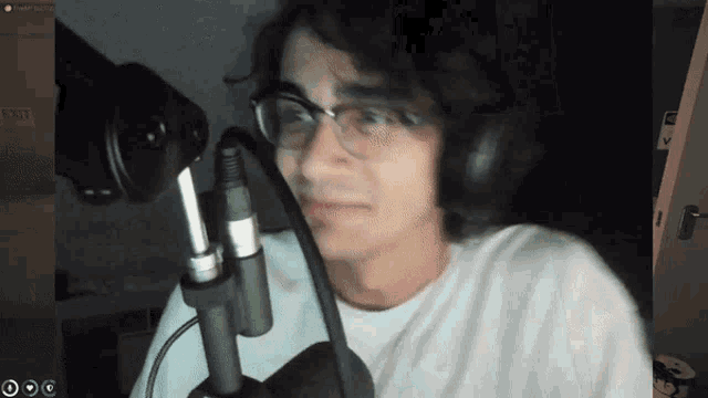 a man wearing glasses and headphones looks at the camera