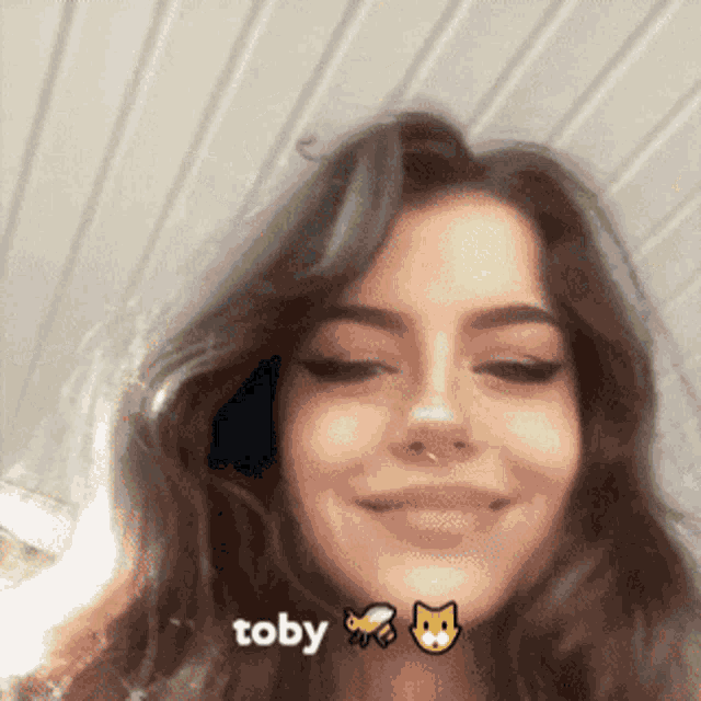 a girl with the name toby on her face is smiling