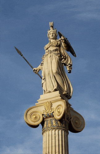 a large statue of a woman holding a spear and shield