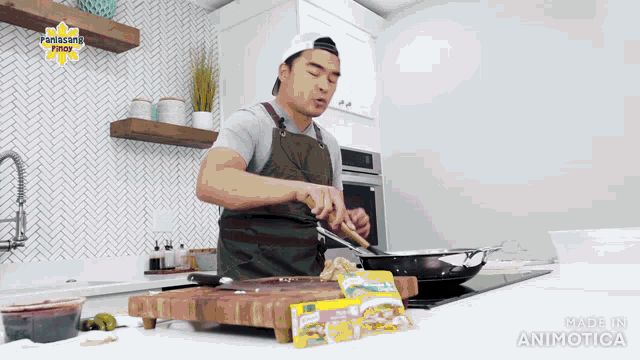 a man in an apron is cooking in a kitchen with a panasonic logo on the wall above him