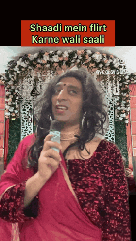 a man dressed as a woman holding a microphone with the words shaadi mein flirt karne wali saali on the bottom
