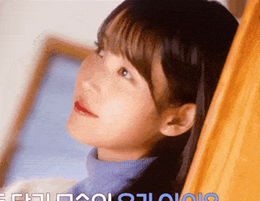 a close up of a woman 's face with the letters eh on the bottom left