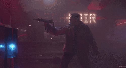a man holding a gun in front of a sign that says technitik