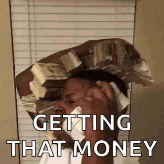 a man is talking on a cell phone while holding a stack of money on his head .
