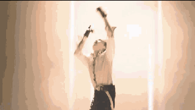 a man in a white shirt and black suspenders is dancing