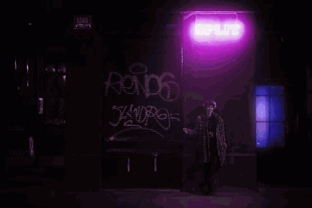 a woman stands in front of a purple light that says rondo on it