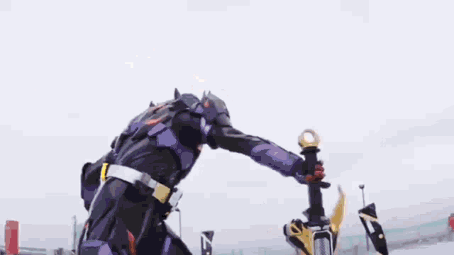 a person in a robot costume is holding a sword and a sword .