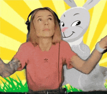 a woman wearing headphones and a pink adidas shirt stands next to a cartoon bunny