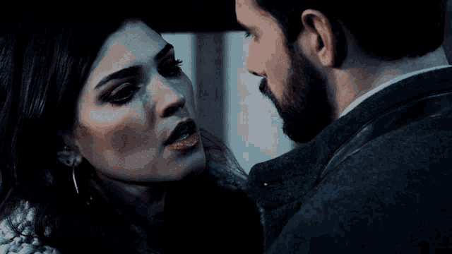 a man and a woman are looking into each others eyes