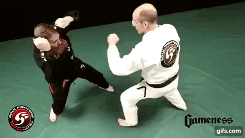 a man in a white shirt with the number 7 on it is fighting another man